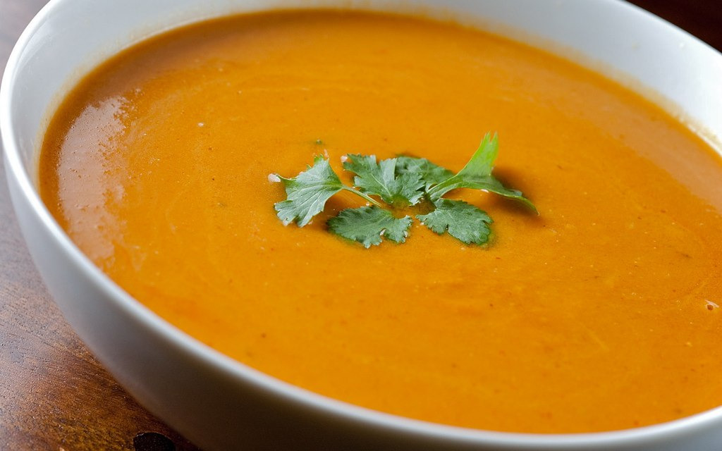 Bowl of roasted butternut squash soup garnished with fresh cilantro